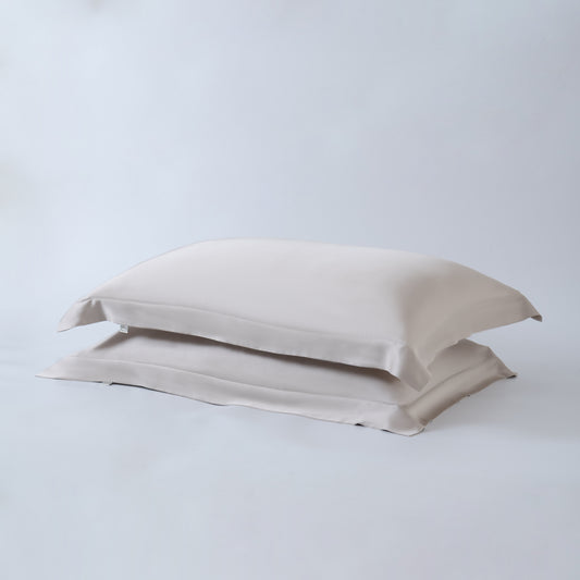 Luxury beige bamboo pillowcase set with breathable temperature-regulating fabric.