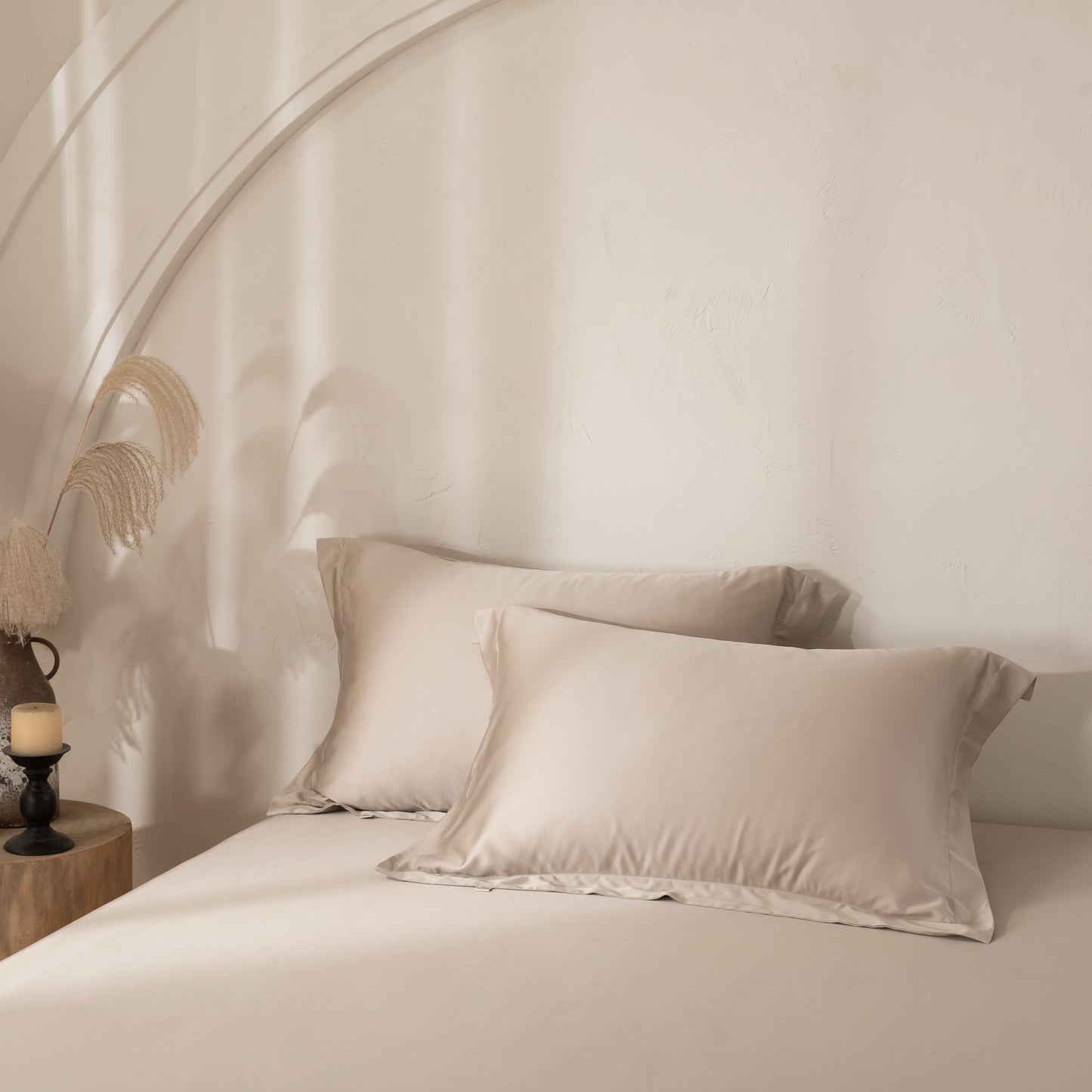 Soft beige bamboo pillowcases styled in a calm neutral bedroom.